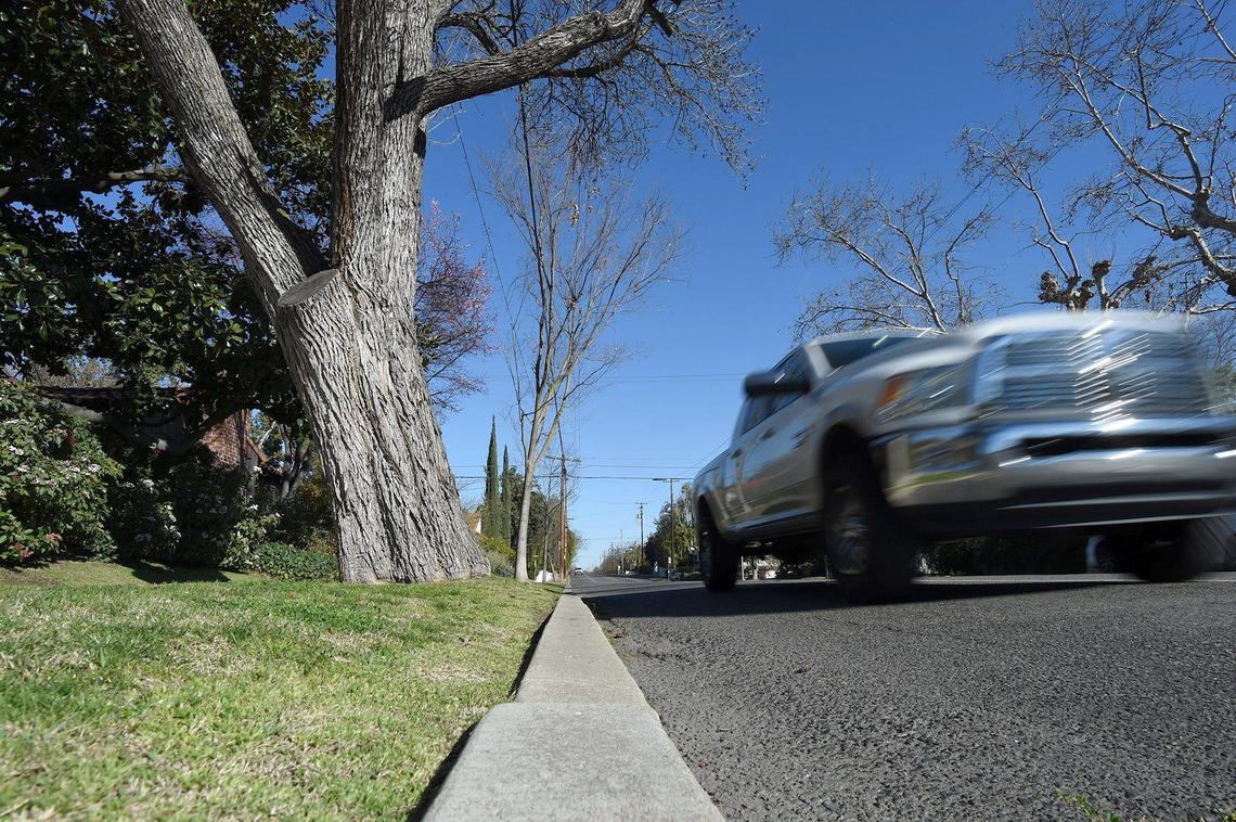A pickup zooms along a southbound lane of Palm Avenue north of Clinton Avenue on Feb. 16, 2022, a few feet from the curb. A bike path will be installed this summer on parts of four-lane Palm, reducing motor traffic to one-lane in each direction.