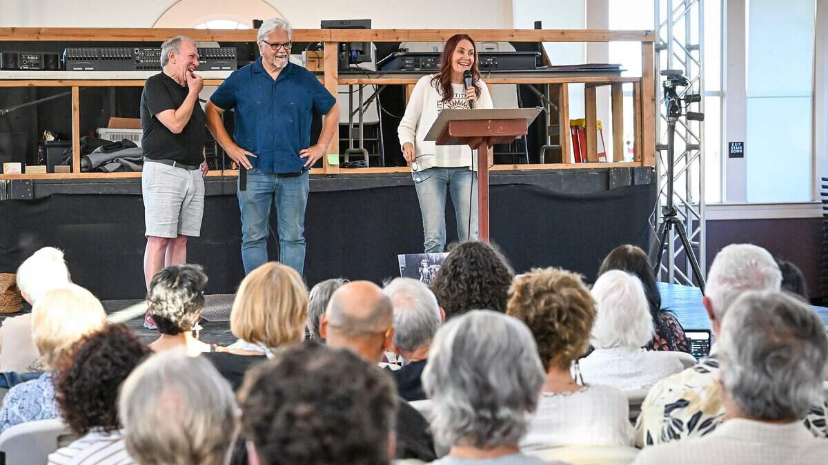 Debi Ruud, owner of Fresno Music Academy & Arts, speaks to an audience of community members and students alongside her husband, John Alden, center, and Dave Brodie, left, who purchased the Severance School of Dance building, during a meeting at the building in Fresno's Tower District on Tuesday, July 7, 2026. Rudd and her husband John Alden held a community meeting at the recently purchased building to get ideas and answer questions about their plan to move their music school into the building.