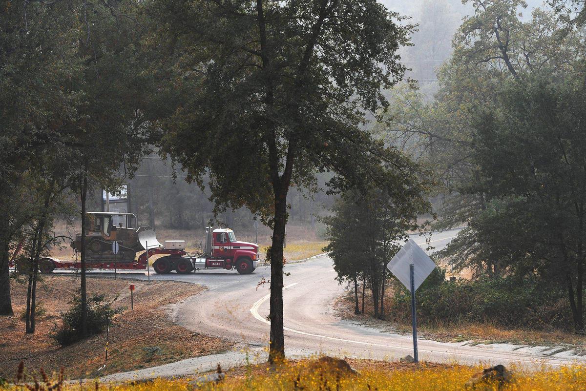 A Calfire truck hauling heavy machinery backs up into a parking spot after most residents evacuated from Big Sandy Rancheria due to the Creek Fire Monday, Sept. 14, 2020 near Auberry.