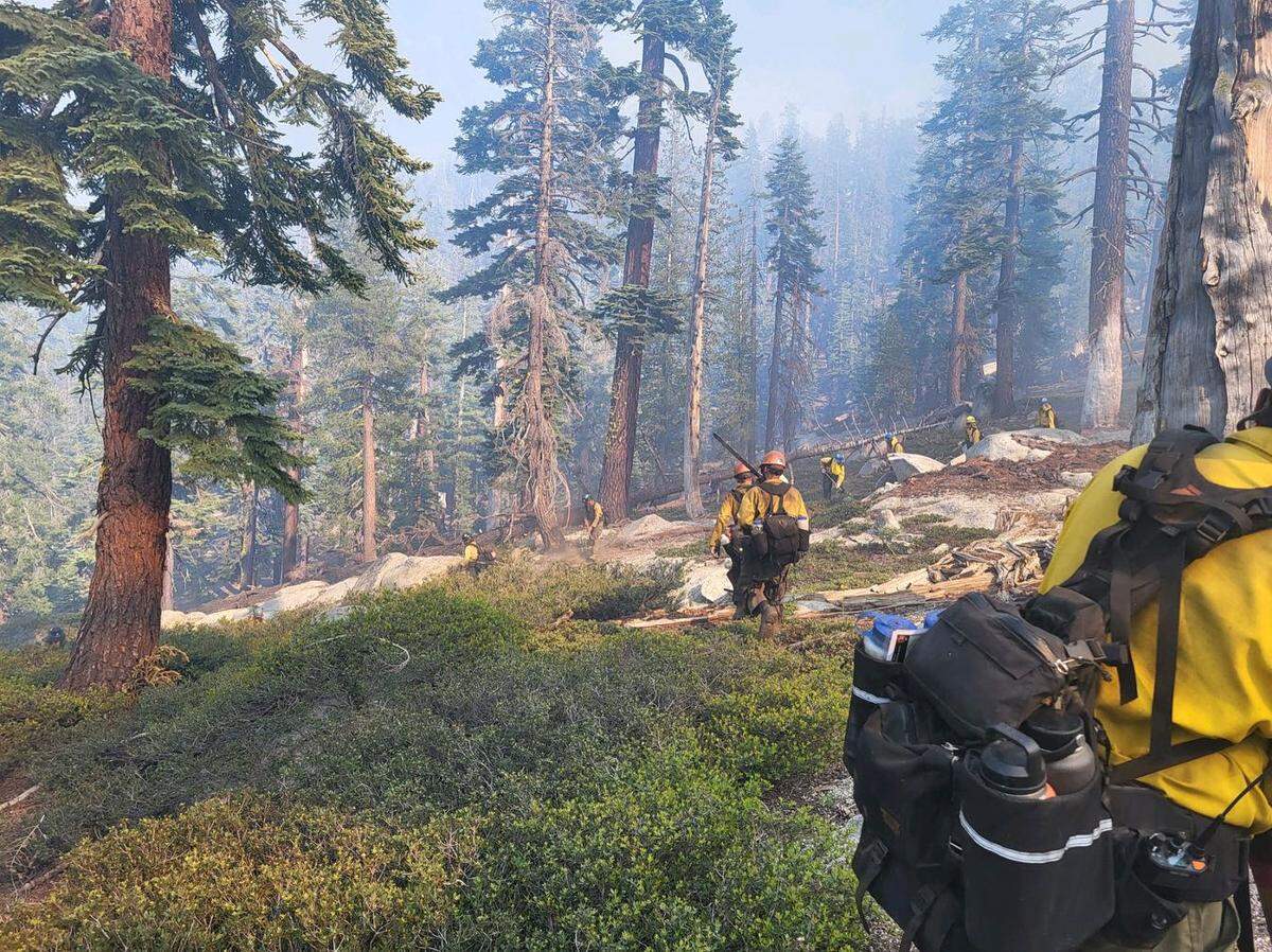Crews work near the Pika Fire in Yosemite National Park near North Dome in the northeastern part of Yosemite Valley.