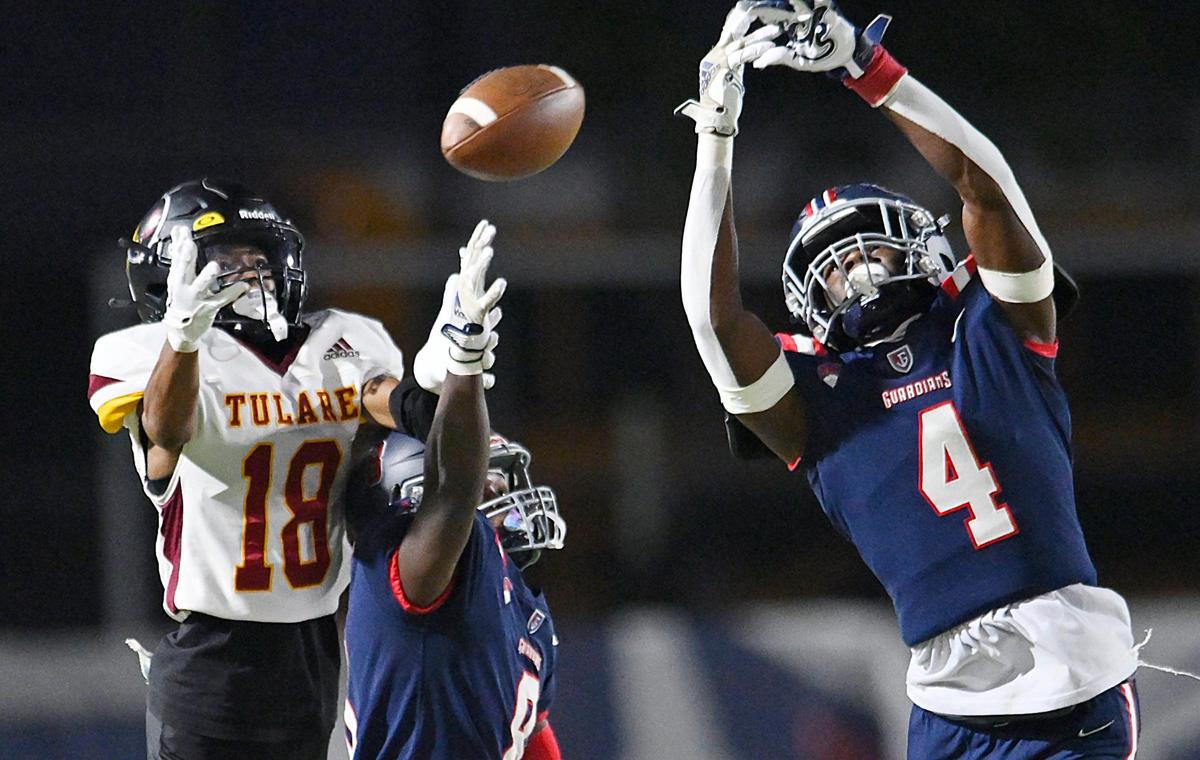 Garza’s Nacho Miller, center, and Omari Bogan, right, break up a pass intended for Tulare Union’sDemaje Riley, left, in forst half action Thursday, Sept. 7, 2023 in Fresno. Tulare led Garza 35-28 at halftime.