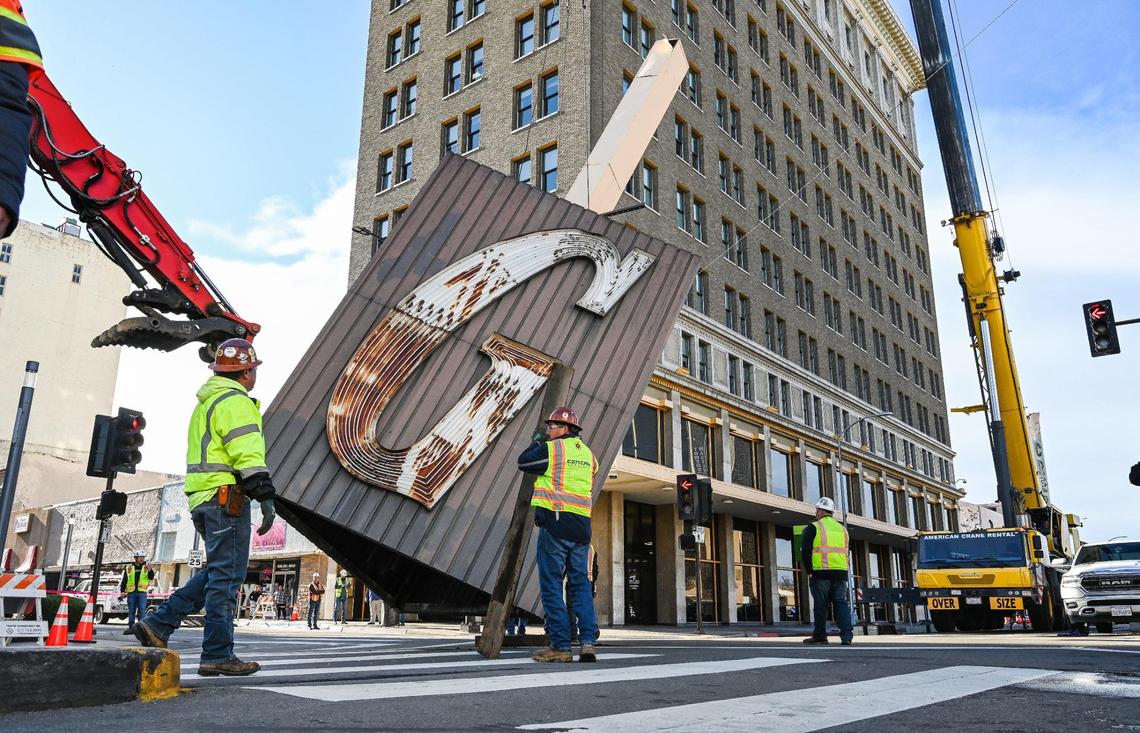 The Guarantee Bank G sign touches Fresno Street at Fulton after finally being removed from the Guarantee Bank building in downtown Fresno on Saturday, Feb. 3, 2024.