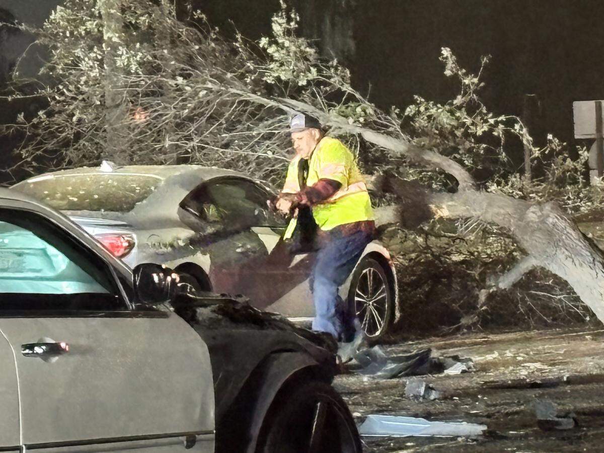 A worker clears wreckage following a crash on Shaw Avenue near Highway 41 on Monday night, Feb. 2, 2026.
