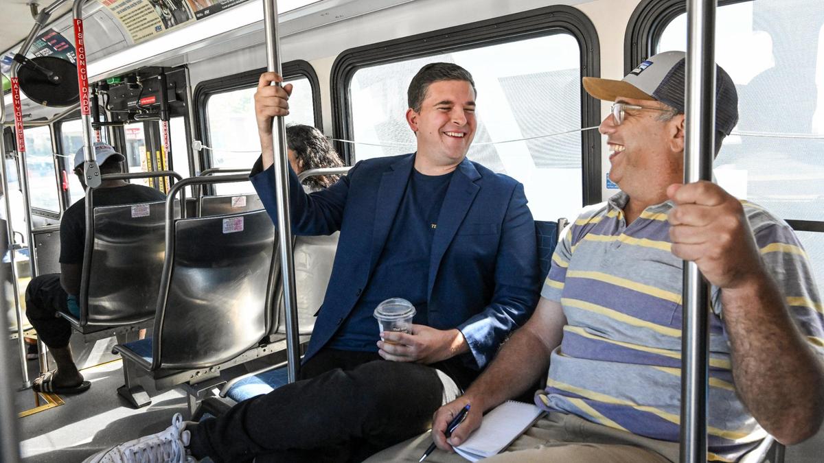 Fresno City Councilmember Tyler Maxwell, center, rides a Fresno FAX bus with Fresno Bee columnist Marek Warszawski on Tuesday, Aug. 15, 2023.