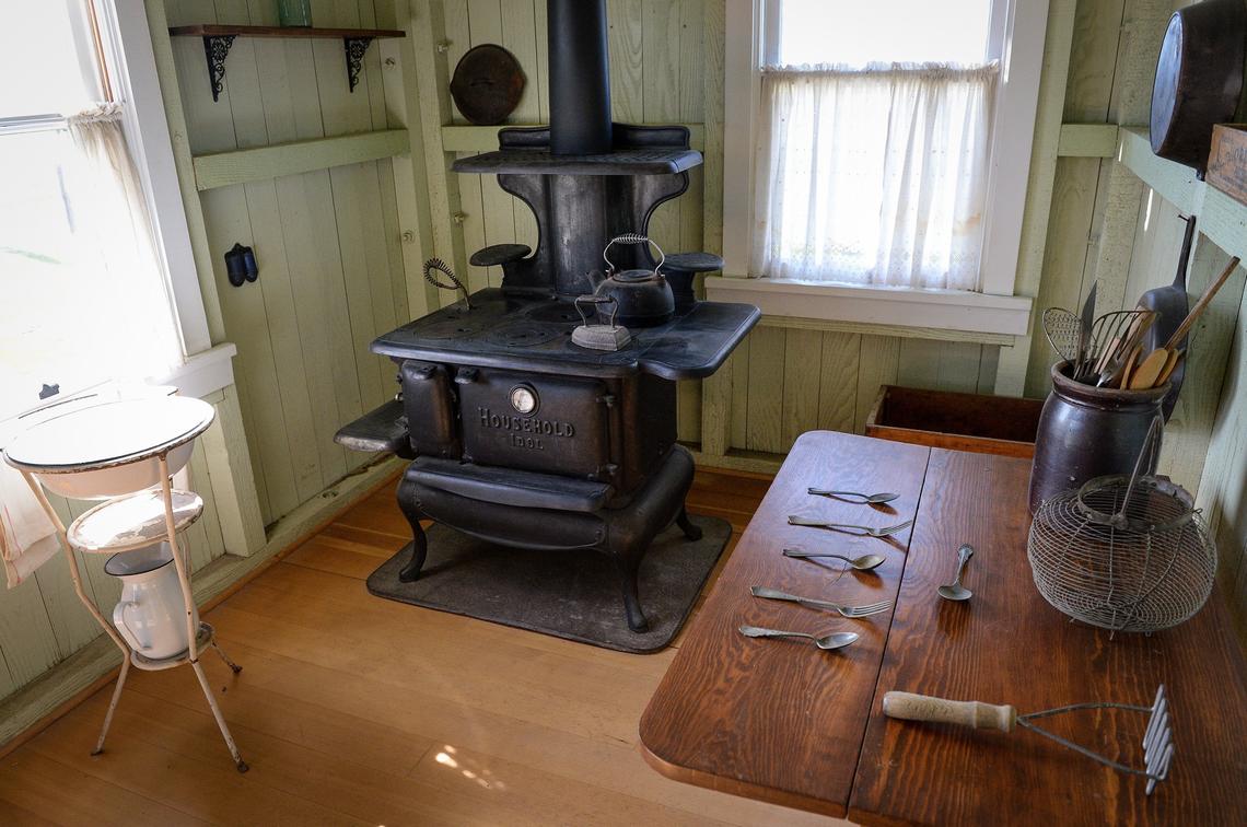 An old stove and kitchen utensils are displayed in a home at Colonel Allensworth State Historic Park near Earlimart on Thursday, Feb. 7, 2019.