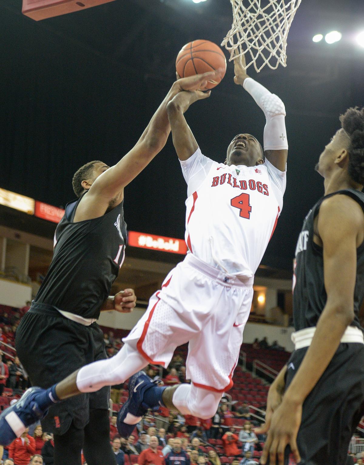 Fresno State’s Braxton Huggins gets fouled by San Diego State’s Matt Mitchell while going to the hoop in their game at the Save Mart Center on Tuesday, Jan. 22, 2019.