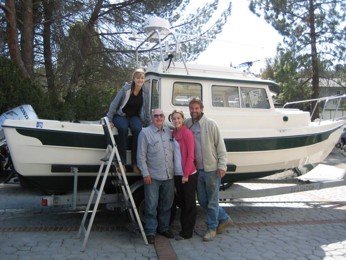 Jack Yandell with family members beside his fishing boat, JoAnn, named after his late wife.