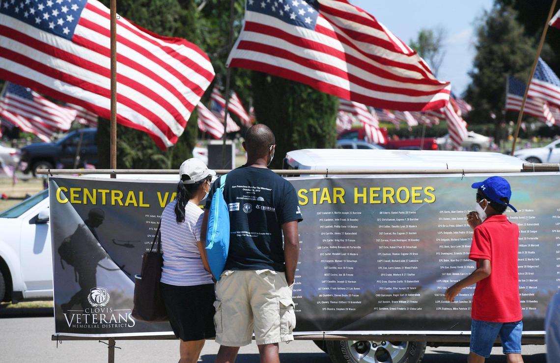 Names are read on a large banner before the start of the 59th Annual VFW Memorial Day Service at Fresno Memorial Gardens Monday, May 30, 2022 in Fresno.