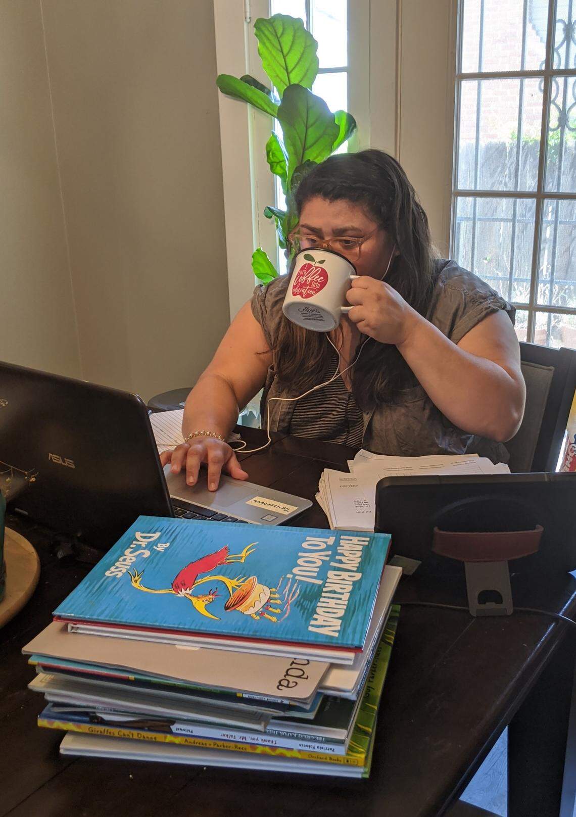 Kelly Castillo, a special education teacher at Susan B. Anthony Elementary School, working at her home work station while schools were closed to help slow the spread of coronavirus.