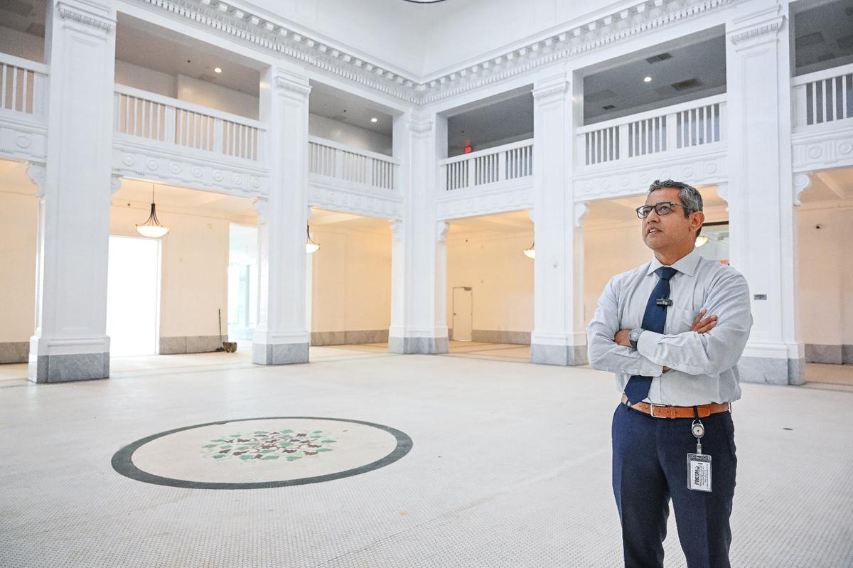 Fresno City Councilmember Miguel Arias looks over the ground floor lobby of the Hotel Fresno as it finally becomes ready to be used for city events.