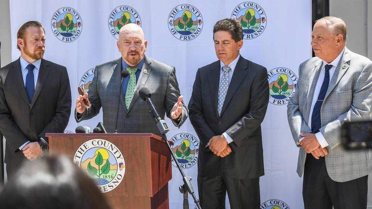 Members of the Fresno County Board of Supervisors, from left, Nathan Magsig, Steve Brandau, Brian Pacheco and Buddy Mendes hold a news conference outside the Hall of Records in downtown Fresno on Tuesday, Aug. 10, 2021. (Bee file photo)