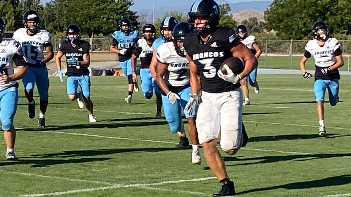 Clovis North senior running back McKay Madsen runs with the ball. The Broncos enter the season ranked No. 1 by The Fresno Bee.