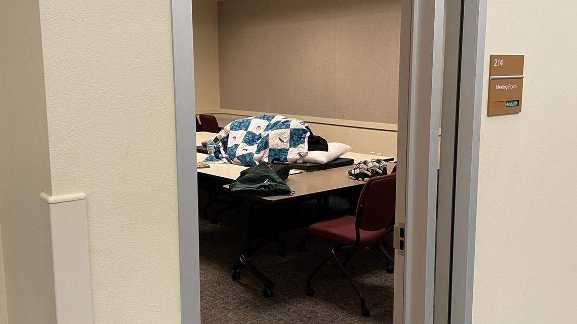 A child rests on a conference table at a county social services office building in Fresno.