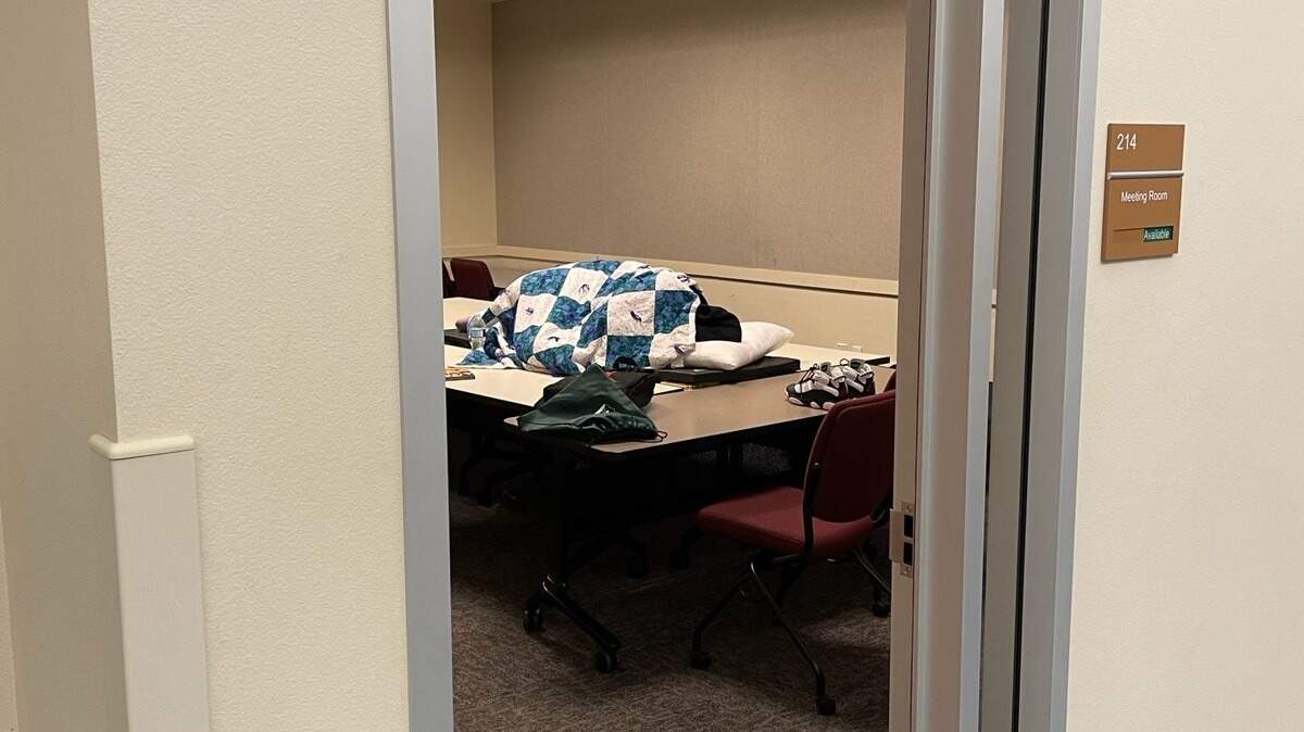 A child rests on a conference table at a county social services office building in Fresno.
