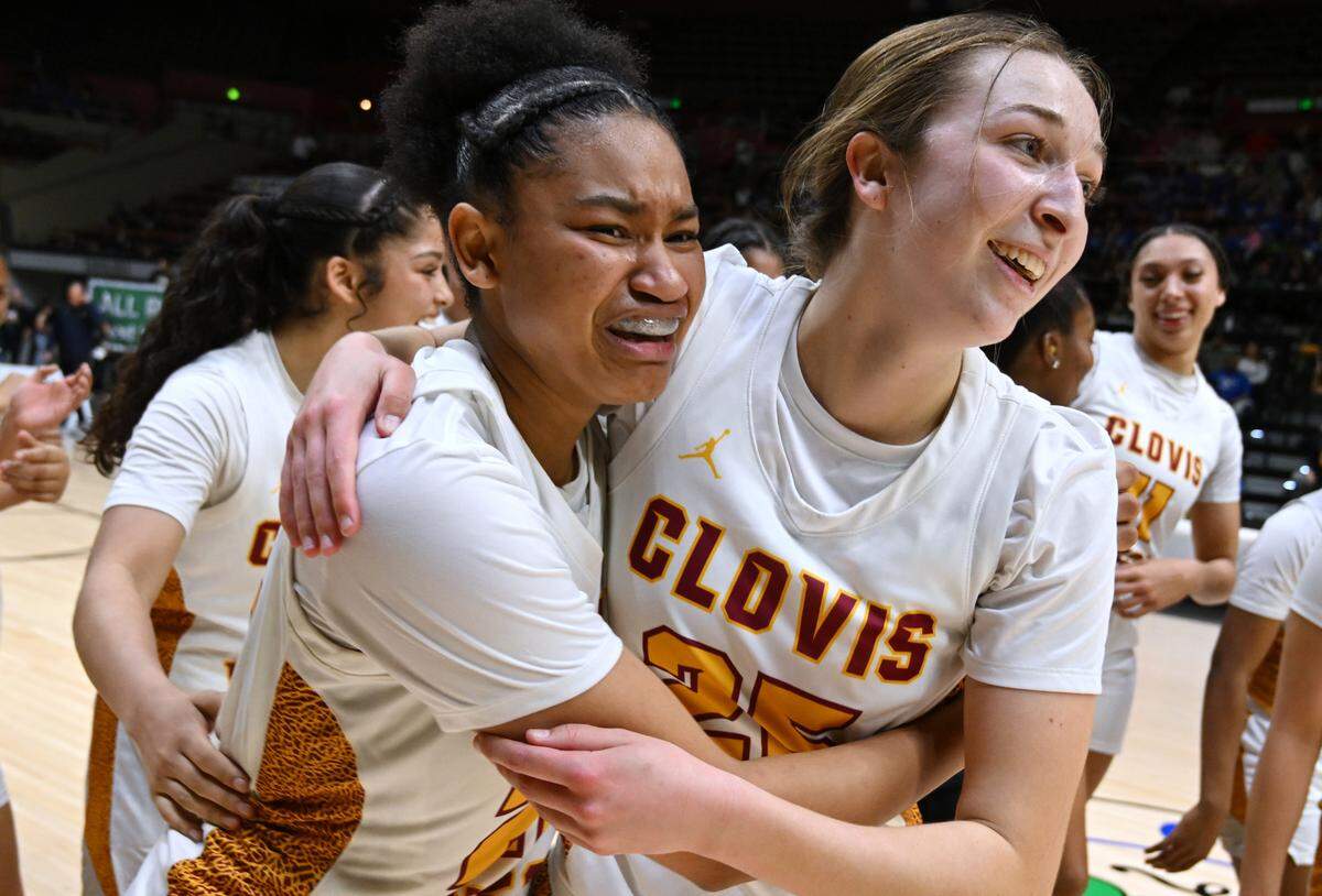 Clovis West’s Riley Walls, left, holds Keegan Medeiros, right, as the team celebrates its win against Clovis High in the CIF Division I Girls Basketball Championship Saturday, March 1, 2025 in Fresno.