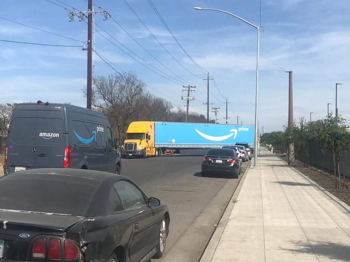 An Amazon truck blocks street traffic in south Fresno as the driver backs into the e-commerce company’s delivery station on Cedar and Florence avenues, as seen in March 2022.