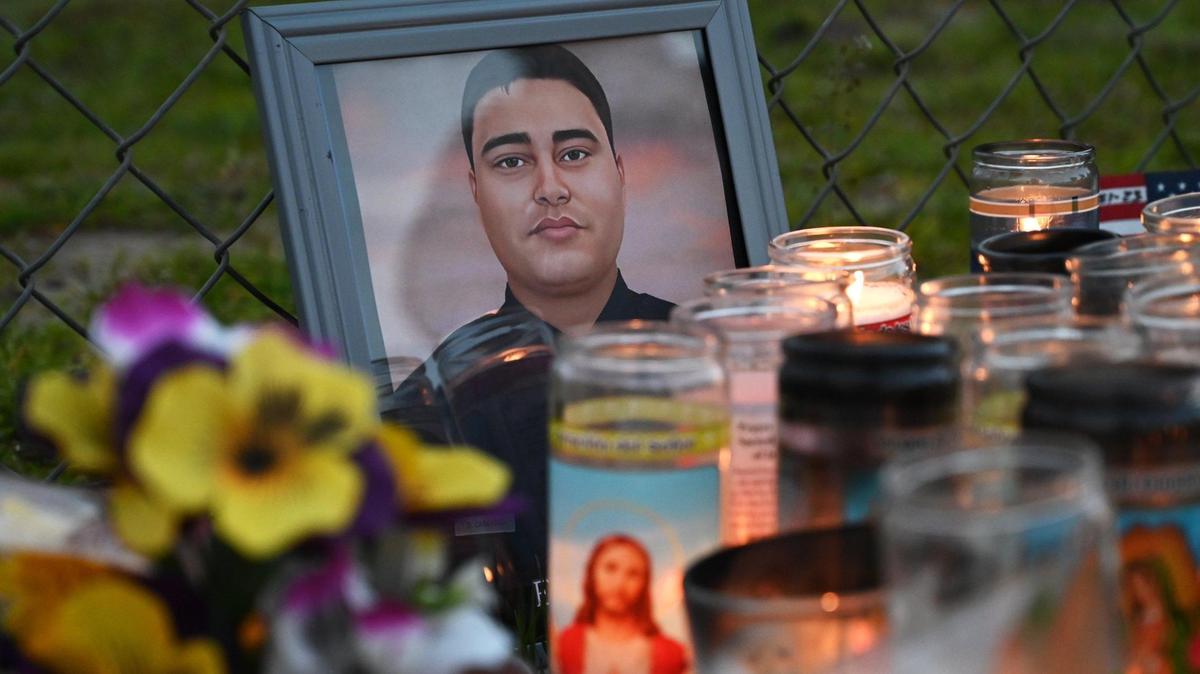 A photo of slain Selma officer Gonzalo Carrasco Jr. is seen at a curbside memorial along Pine Street on Thursday evening, Feb 2, 2023 in Selma.