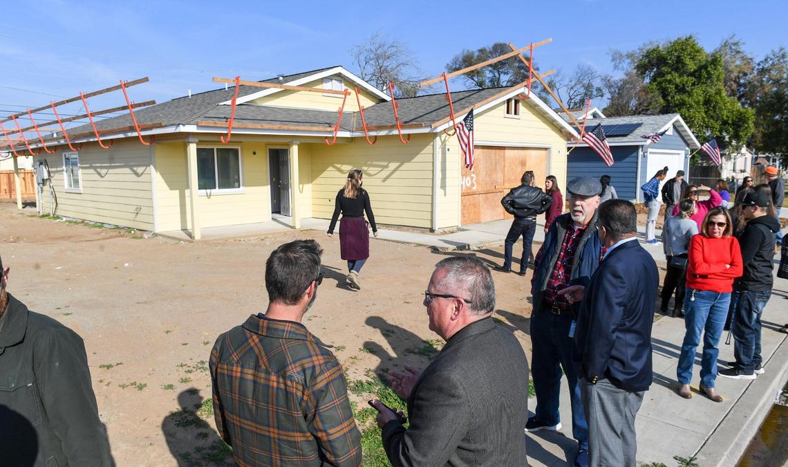 City of Clovis and Habitat for Humanity Greater Fresno Area officials wait outside an unfinished Habitat for Humanity home build in Clovis before announcing the family selected for the home on Wednesday, Dec. 8, 2021.