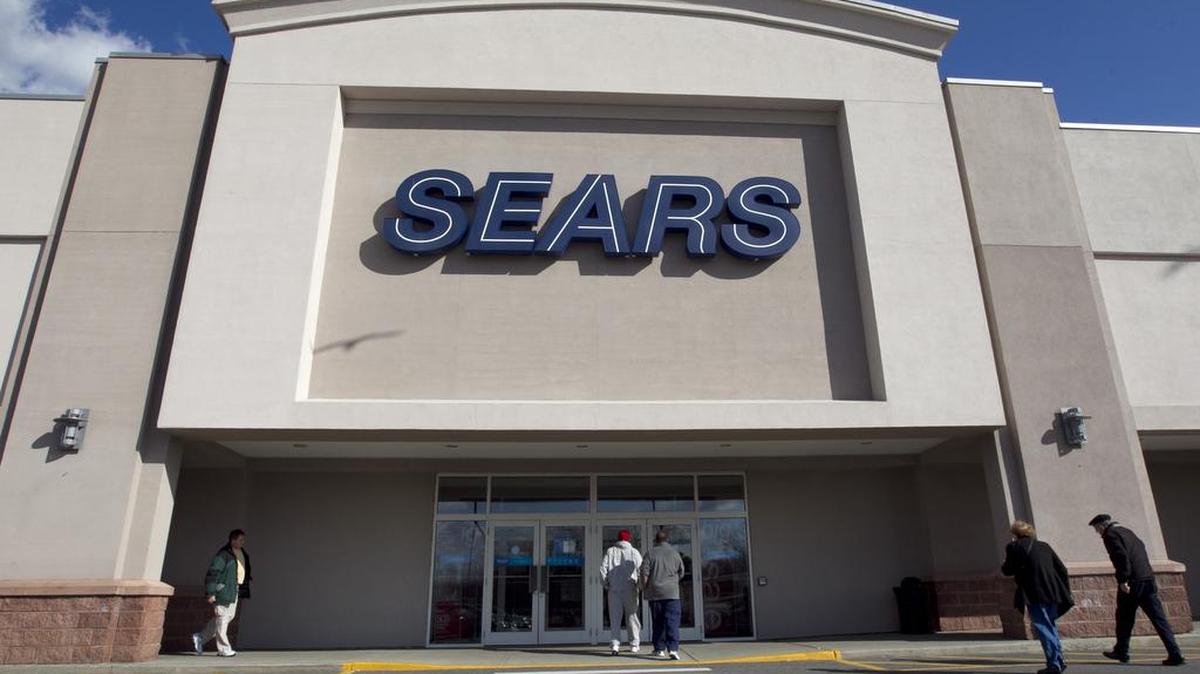 Shoppers enter a Sears store location in Dedham, Mass. Sears’ parent company plans to close 72 more stores nationwide.