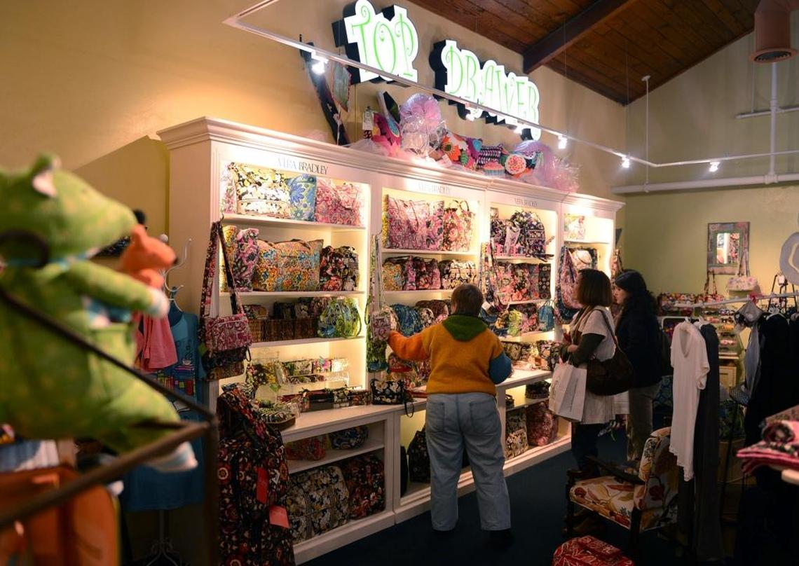 Top Drawer sells Vera Bradley handbags and stationery in Fig Garden Village next to La Boulangerie.