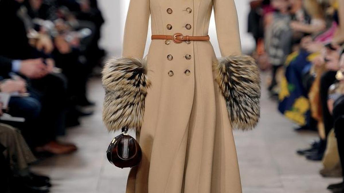A touch of fur helps to transition from to winter. Michael Kors Collection Fox fur cuffed wool melton princess coat, $4495, michaelkors.com.