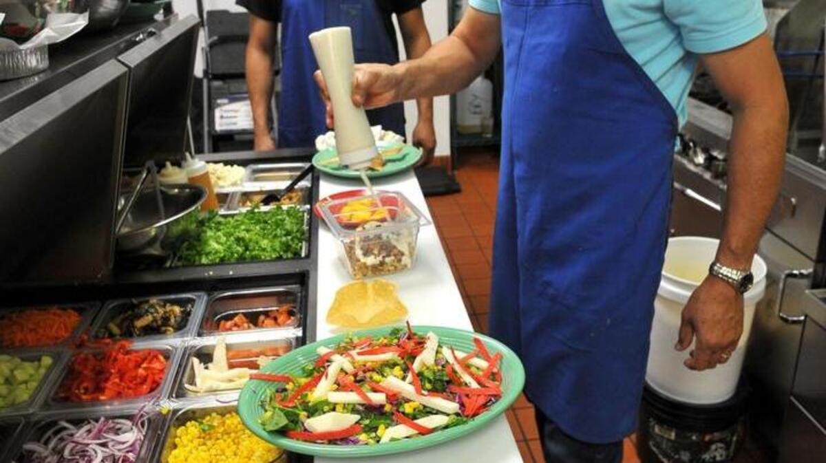 Rafael Figueroa, who owns Figaro’s Mexican Southwestern Grill with his family, prepares colorful salads for diners at the Fowler and Ashlan avenues location. Figaro’s also recently opened a location in Fresno.