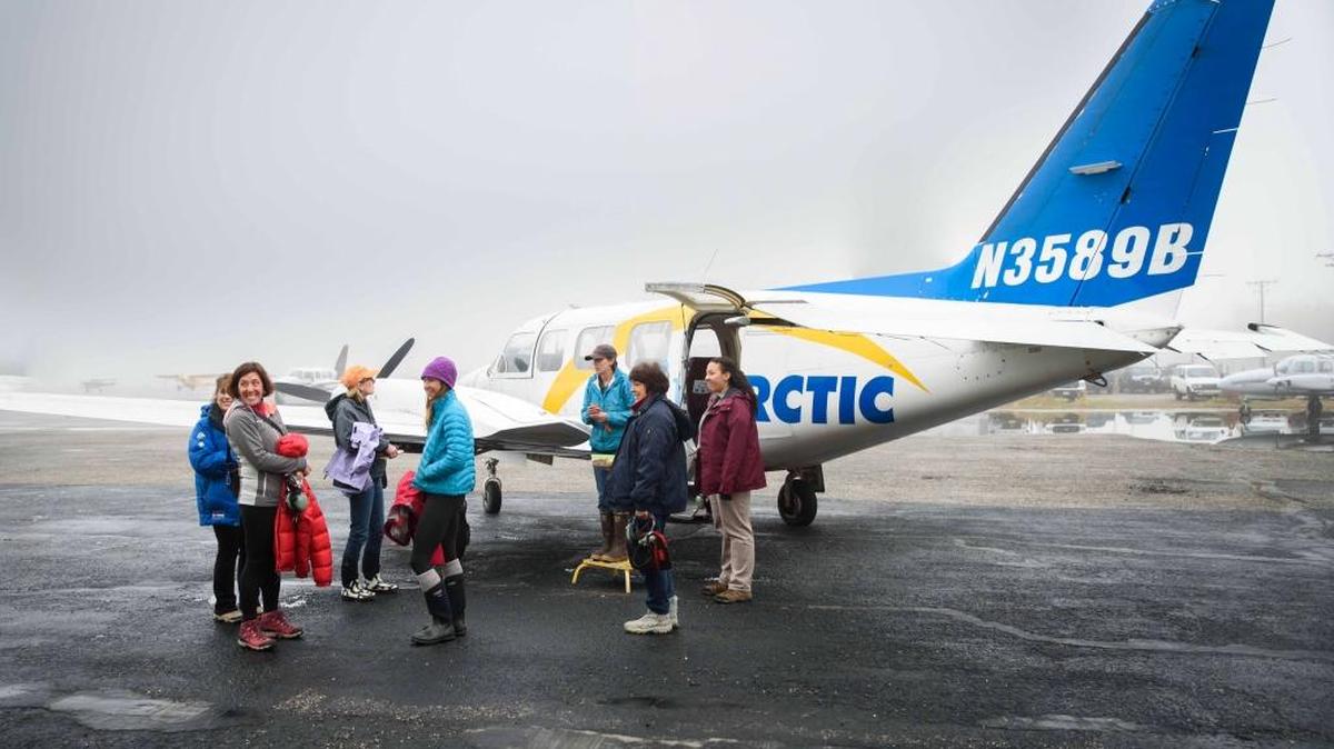 Polar bear tour group preparing to depart Fairbanks, Alaska for Kaktovik, Alaska in a Piper Navajo Chieftain. Day tour costs includes round-trip transportation from Fairbanks, buffet lunch in Kaktovik, and 3-hour guided polar bear boat ride. Kaktovik is one of few places in the world where polar bears can be viewed up close in relative safety.