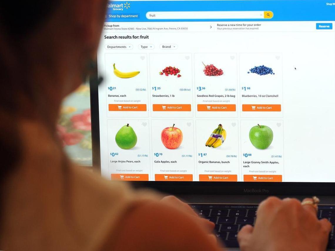 Mandy Silveira shops for fruit online at home with Walmart’s new “click and collect” grocery service on Wednesday morning, Aug. 9, 2017.