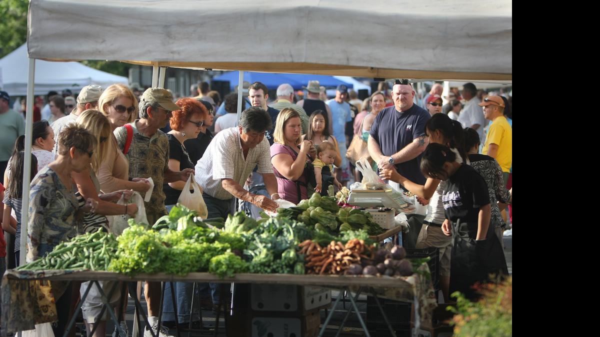 
A peach party will happen at the Old Town Clovis Farmer's Market Friday, July 17. The event will feature free peach cups, recipe demonstrations, peach-flavored dishes for sale and lots of peaches available for purchase. The peach party has been a regular event at the farmers market, photographed here on Friday May 9, 2008, for years.
