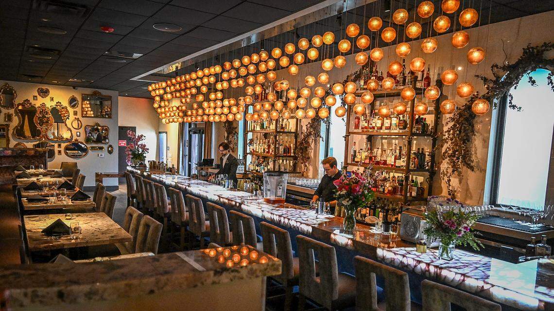 The bar at Bulle in northwest Fresno is shrouded with ornate lighting and mirrors while offering unique cocktails.
