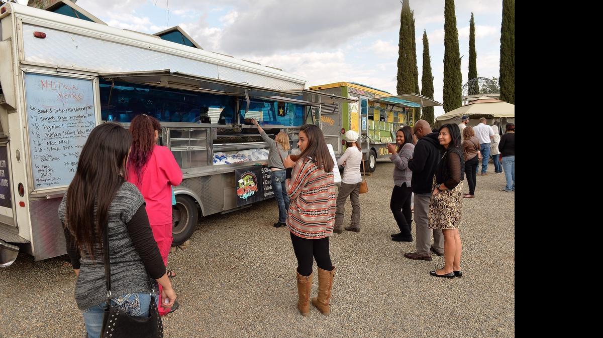 
Crowds gather around the Meltdown Bistro food truck at Gazebo Gardens in Fresno.
