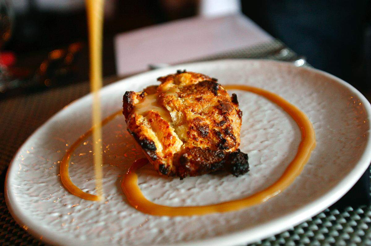 A swirl of caramel is added to the Cracked Pepper Bistro's bread pudding before it is finished with a dollop of whipped cream.