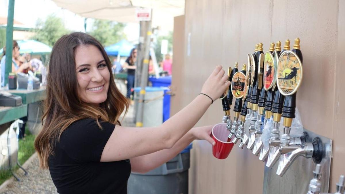 Carley Griffin pouring beer at ApCal, which will host its fourth annual ApCal Craft Beer Festival Saturday, May 14.