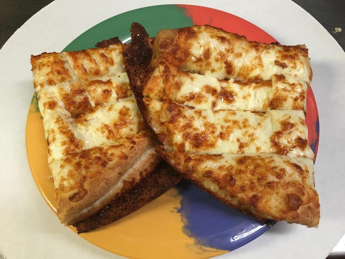 These breadsticks with a white garlic sauce are a favorite at the newly opened More Than Pizza at Bullard and West avenues in Fresno.