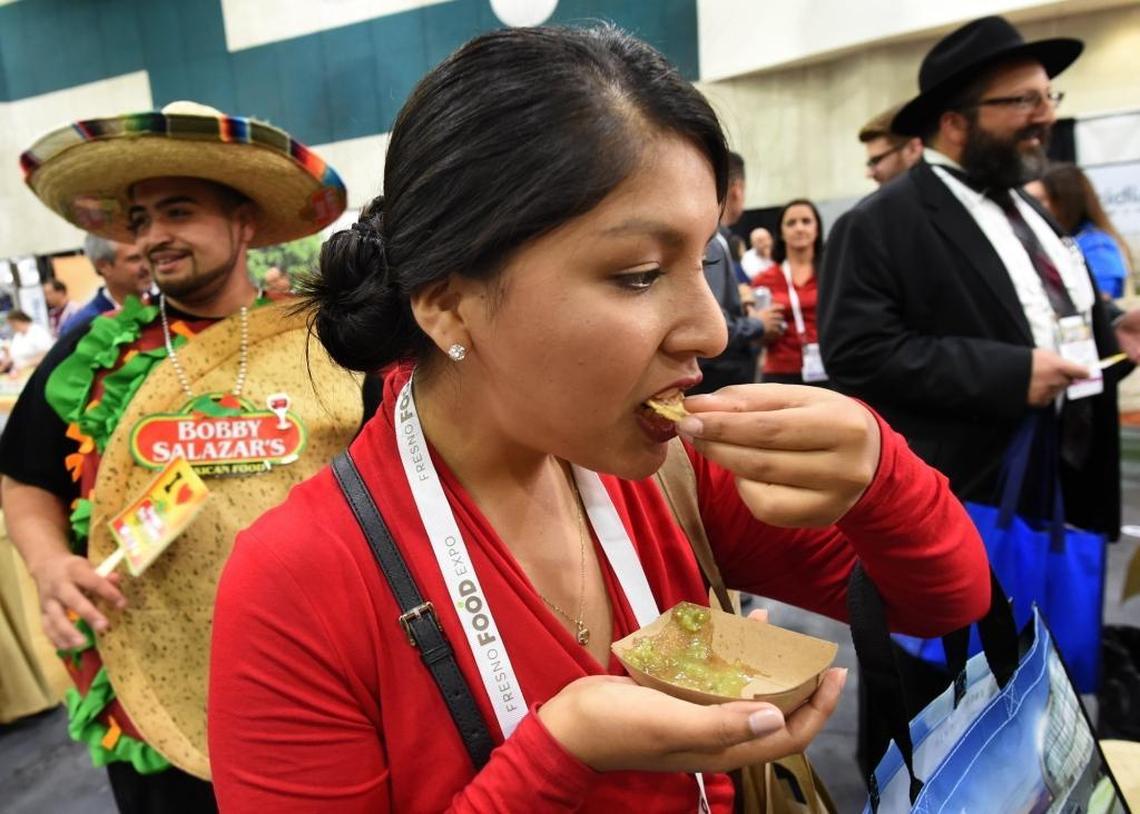 Veronica Romani of the restaurant Goodfellas samples a new product from Bobby Salazar’s during the Fresno Food Expo at the Fresno Convention & Entertainment Center, Thursday afternoon, July 27, 2017.