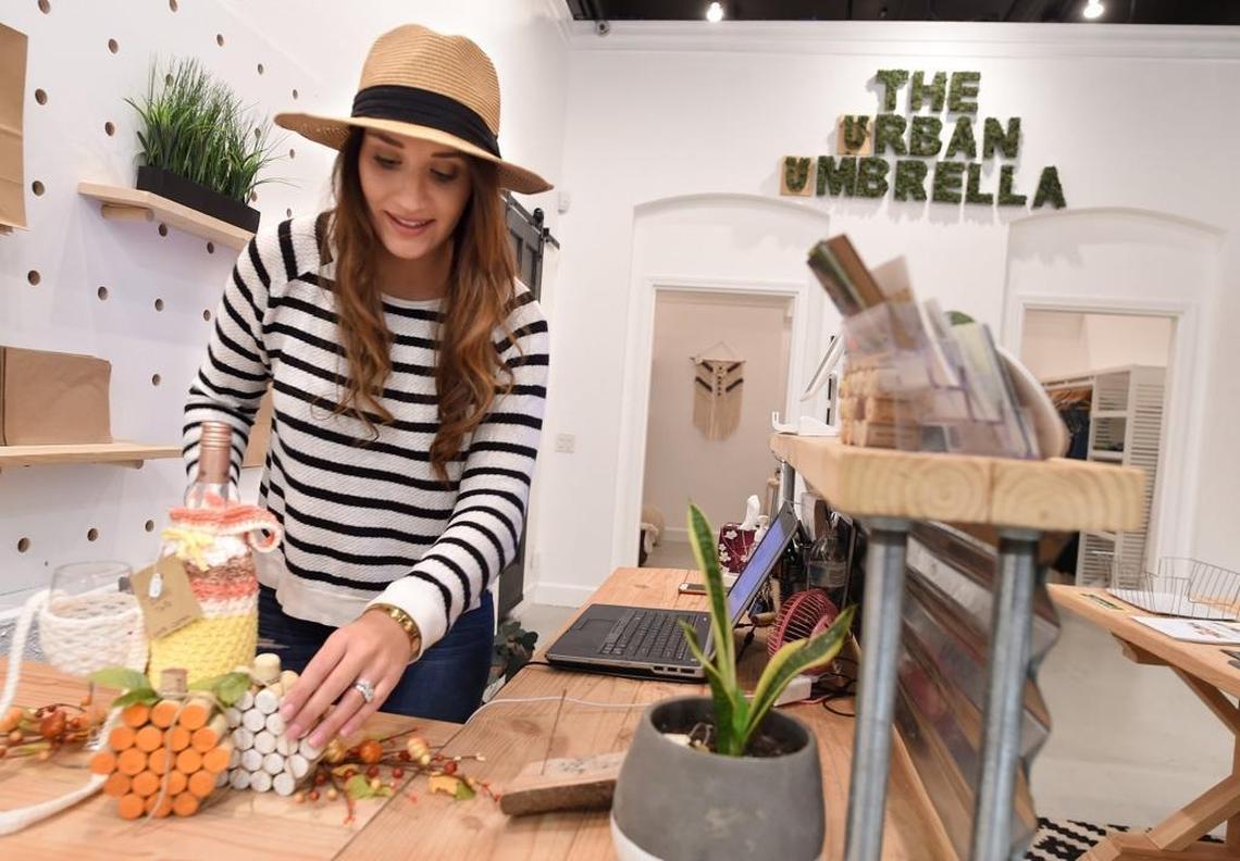 Amy Cortell sets up a display at her shop, The Urban Umbrella, in Old Town Clovis.