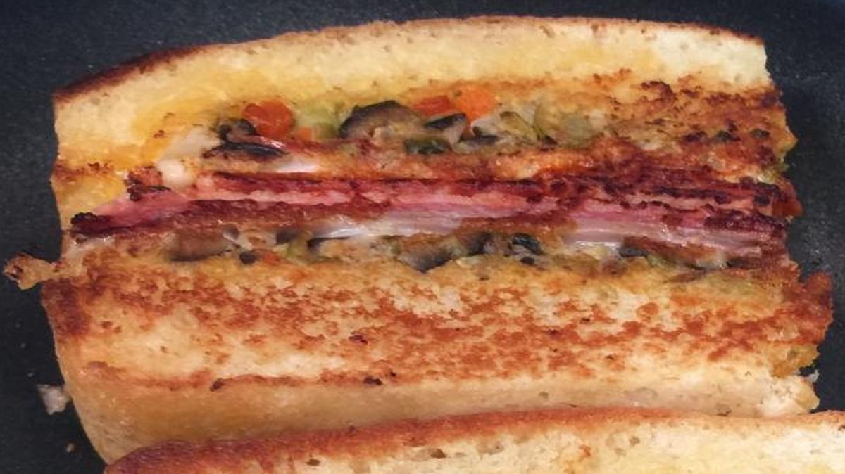 The muffuletta sandwich in the process of being made at Mabel’s Kitchen in downtown Fresno, which has reopened inside Bitwise Industries. The New Orleans inspired sandwich at Mabel’s is made with corned beef, roast beef, ham, mozzarella, pepper jack cheese and an “olive salad” that’s almost like a spread with pickled vegetables, olives and capers.