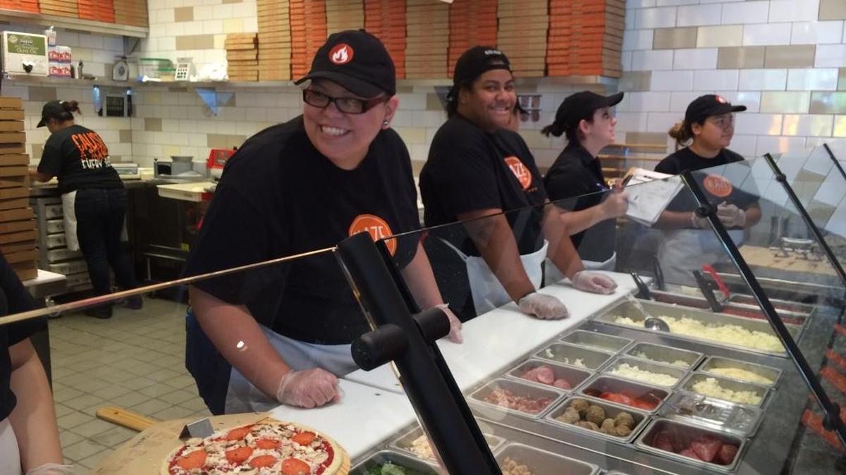
Blaze Pizza employees work on a customized pizza for a customer. The first Blaze Pizza opened in Fresno on Thursday, Sept. 10 at Shaw Avenue and First Street.

