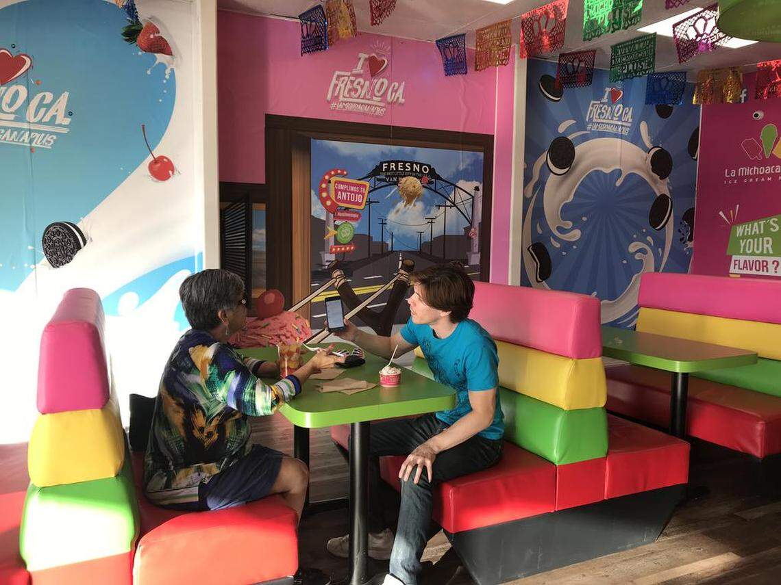La Michoacana Plus Ice Cream Parlor at Tulare Avenue and First Street has several murals that can be used in Instagram photos. Here, a slingshot shoots a scoop of ice cream at the Fresno sign at the south end of town.