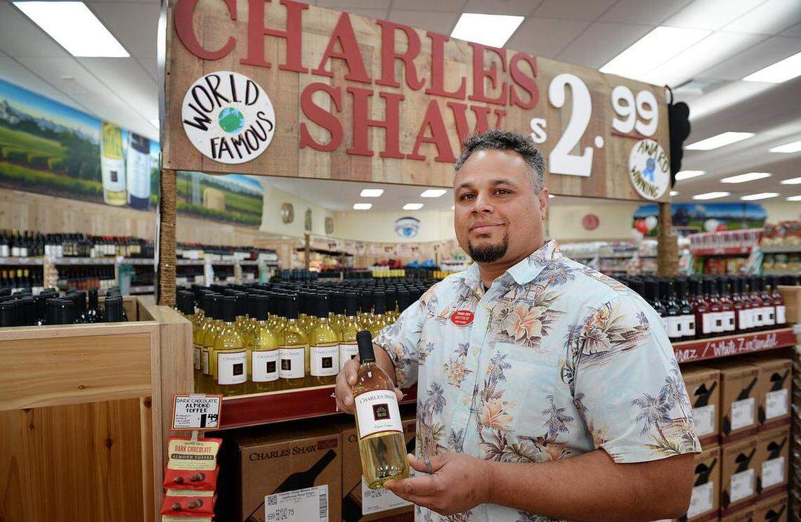 Matthew Parry, the “captain” of the new Trader Joe’s market on Friant Avenue at Fresno Street in north Fresno, stands among the Charles Shaw wines at the store on Thursday, Feb. 15, 2018.