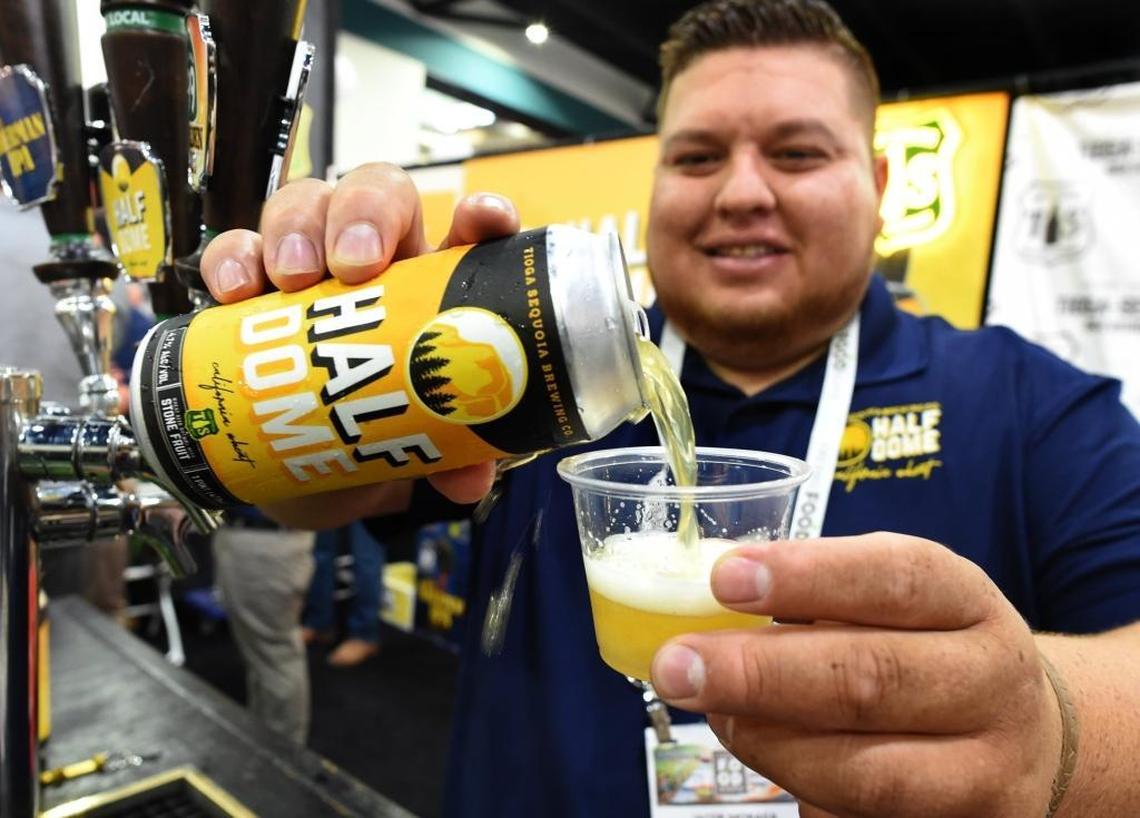 Jacob Moraga of Tioga-Sequoia Brewing Company pours a heady sample of the golden Half Dome beer during the Fresno Food Expo at the Fresno Convention & Entertainment Center, Thursday afternoon, July 27, 2017. It won an award at the event.