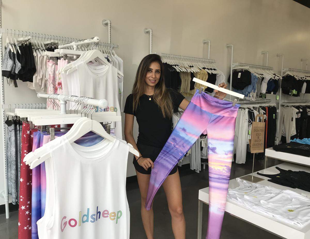 Alma Wolverton, owner of MANTRA, displays leggings her River Park store. The store is closing Nov. 1 but the merchandise will be available at another River Park location.