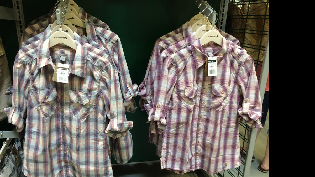 
The newly opened Sportsman’s Warehouse carries gear for hunters, campers and people who fish, but also casual clothing and shoes for women, men and children. Pictured are plaid button-down Carhartt shirts for women. 
