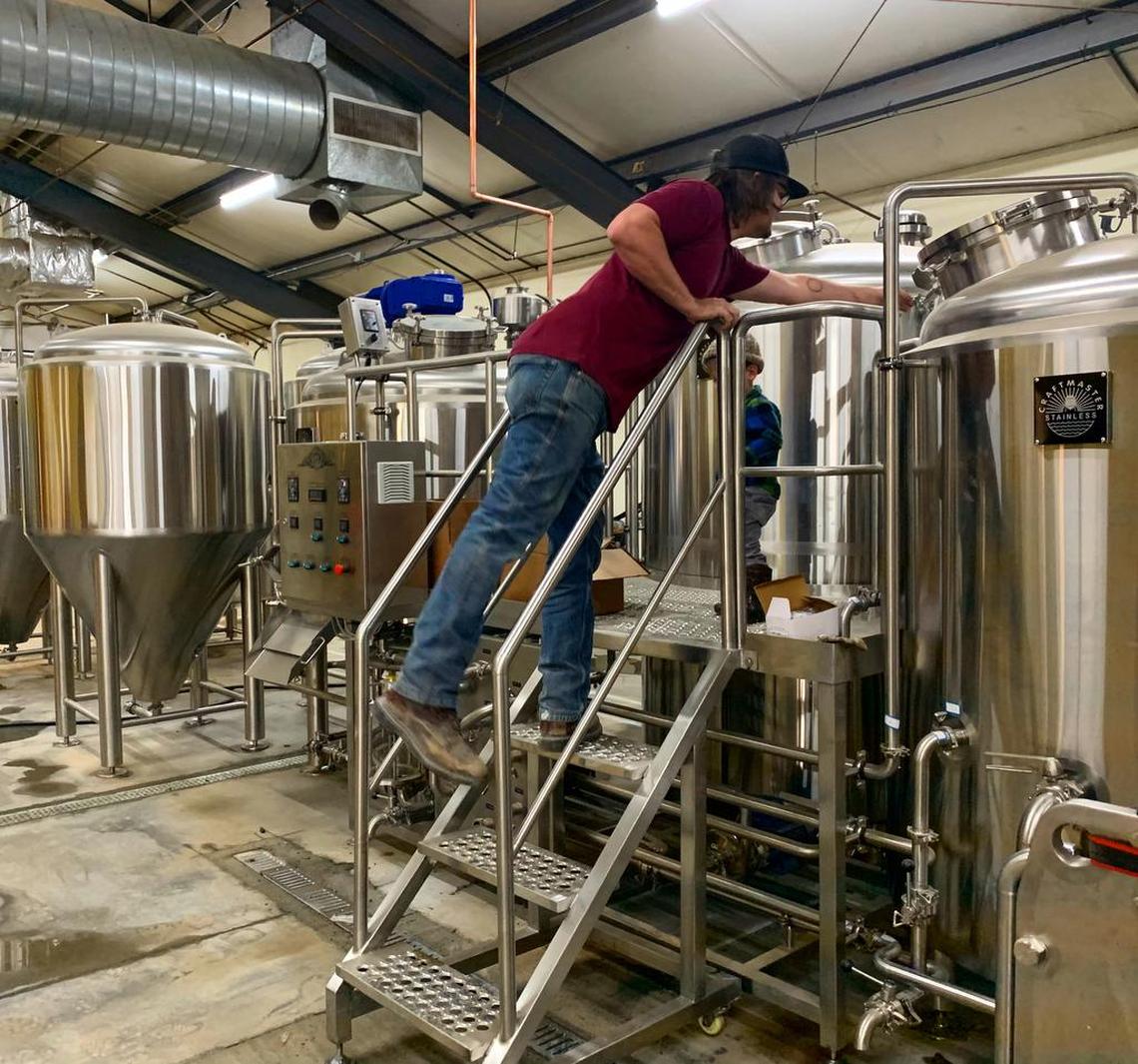 Amalgamation Brewing Co. head brewer is Stephen Koch checks on beer at the brewery that will soon open in northwest Fresno.