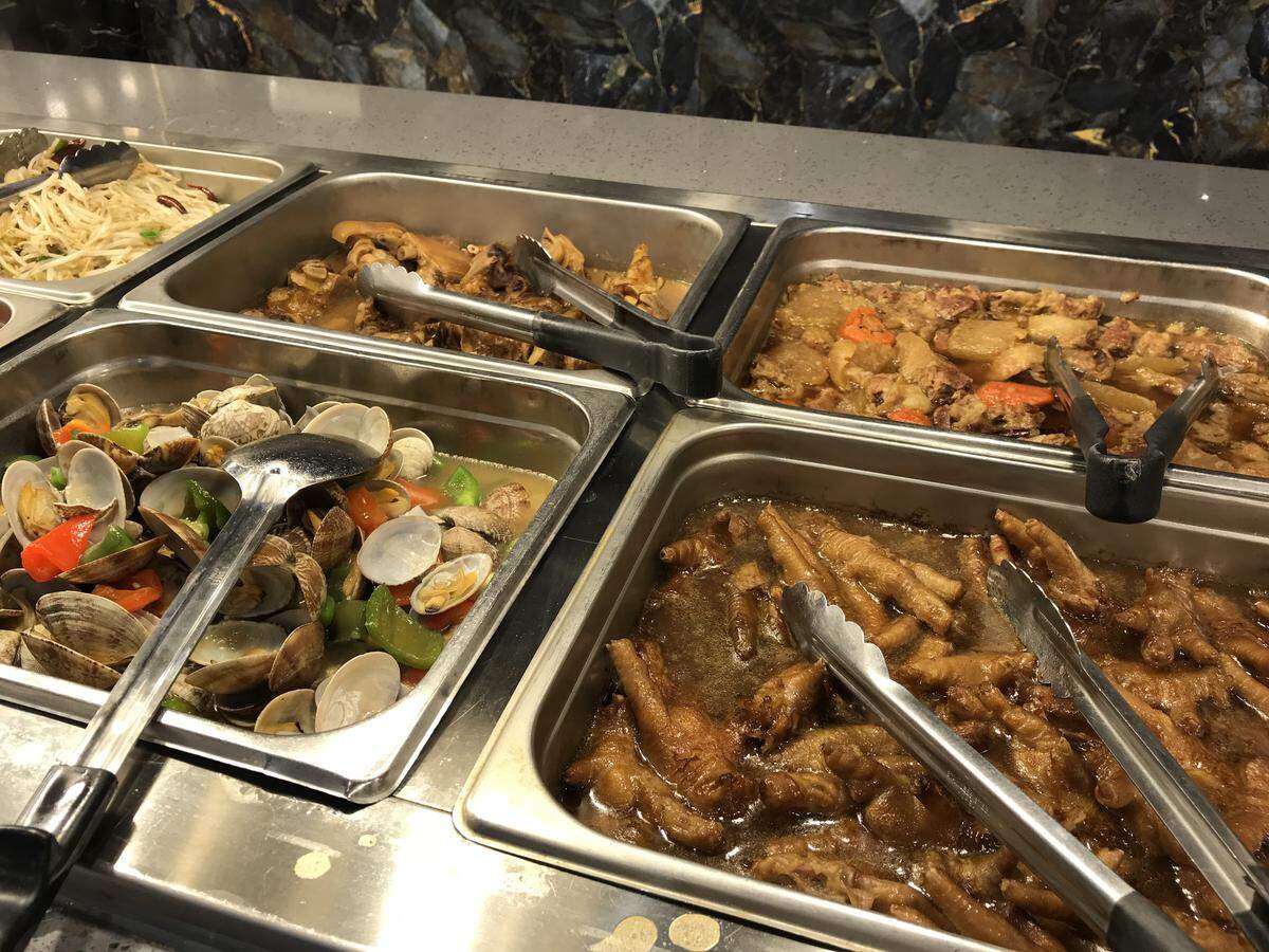 Victual Buffet serves Asian fusion food like five-spice chicken feet in brown sauce, lower right, black bean clams on the lower left and pigs feet just above it.