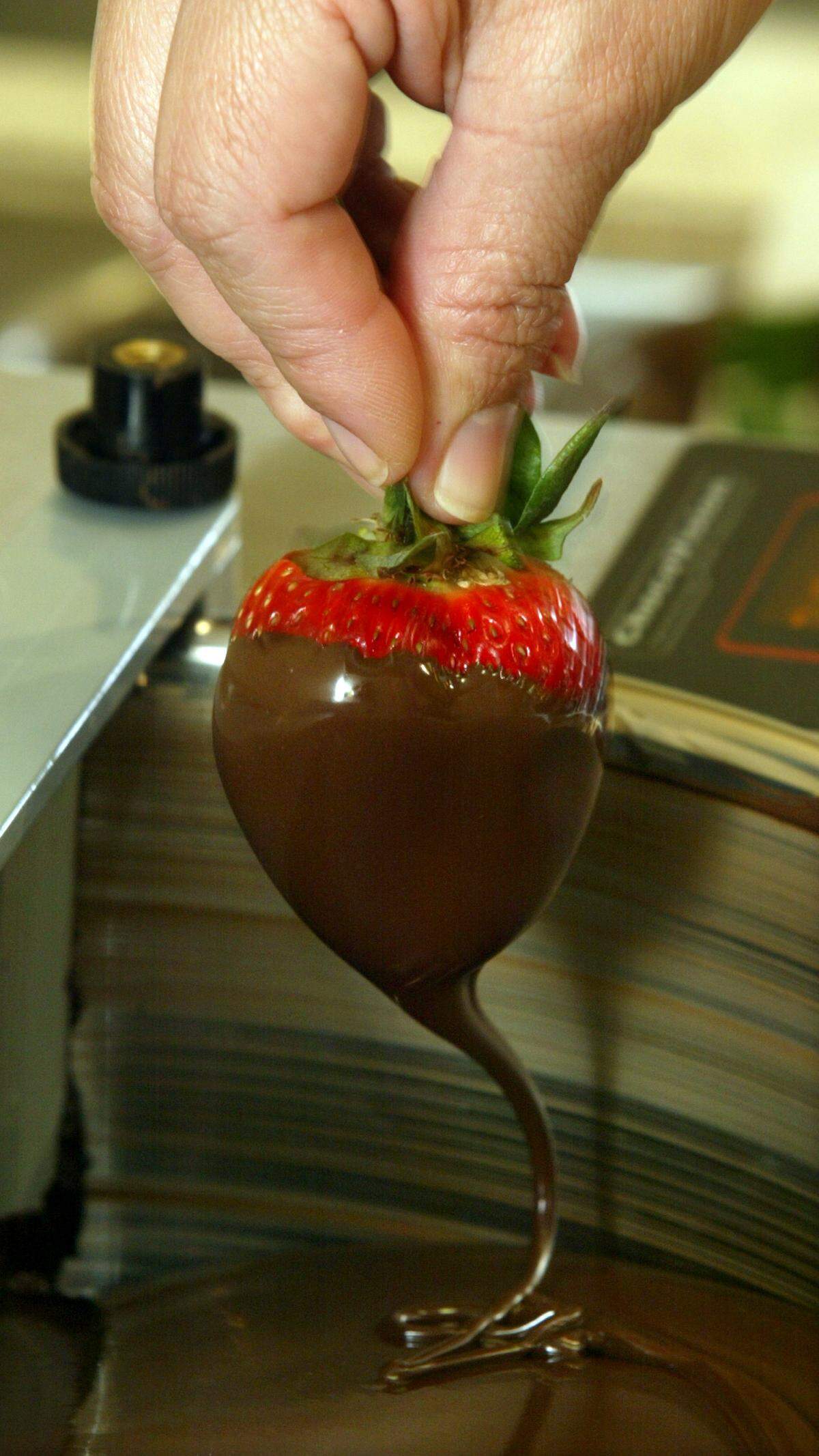 Rocky Mountain Chocolate Factory in River Park will reopen selling goodies like this chocolate-dipped strawberry.