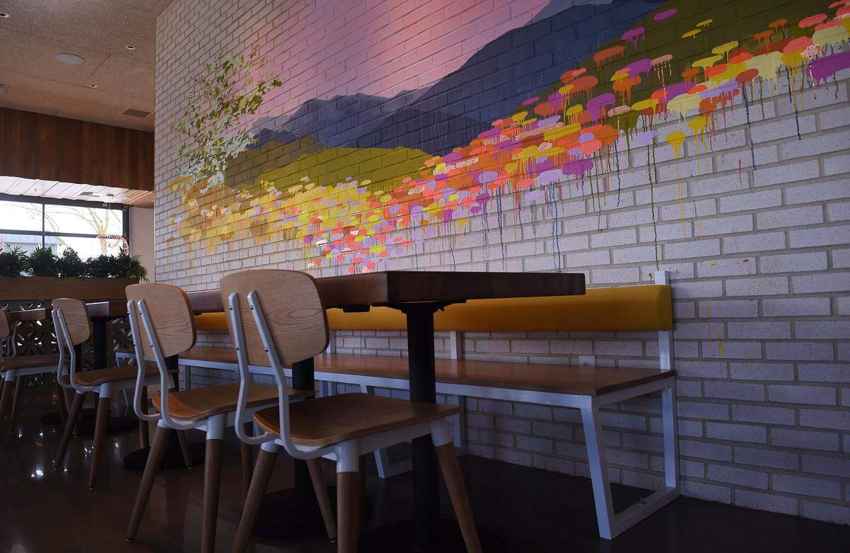 The interior of Heirloom, which opened in 2019 in north Fresno, features a mural on an interior wall.