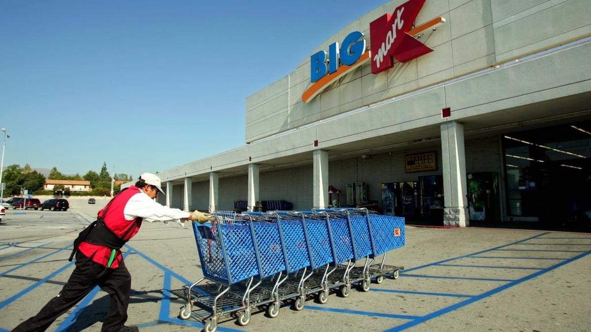 A Kmart employee pushes shopping carts into the store in the Northridge section of Los Angeles Wednesday in this file photo from 2004.