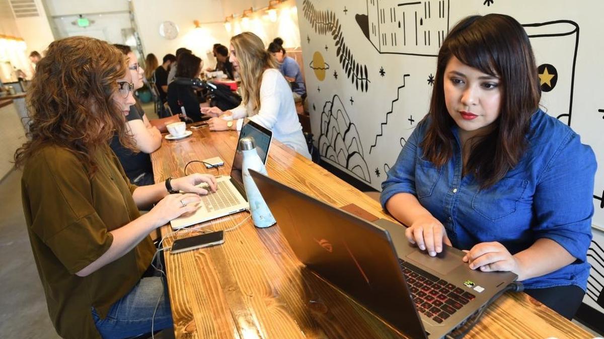 Michah Garcia, right, prepares for her podcast “Dreamers That Do,” at the newly opened Hi-Top Coffee shop in the Tower District, Friday morning, Sept. 15, 2017.