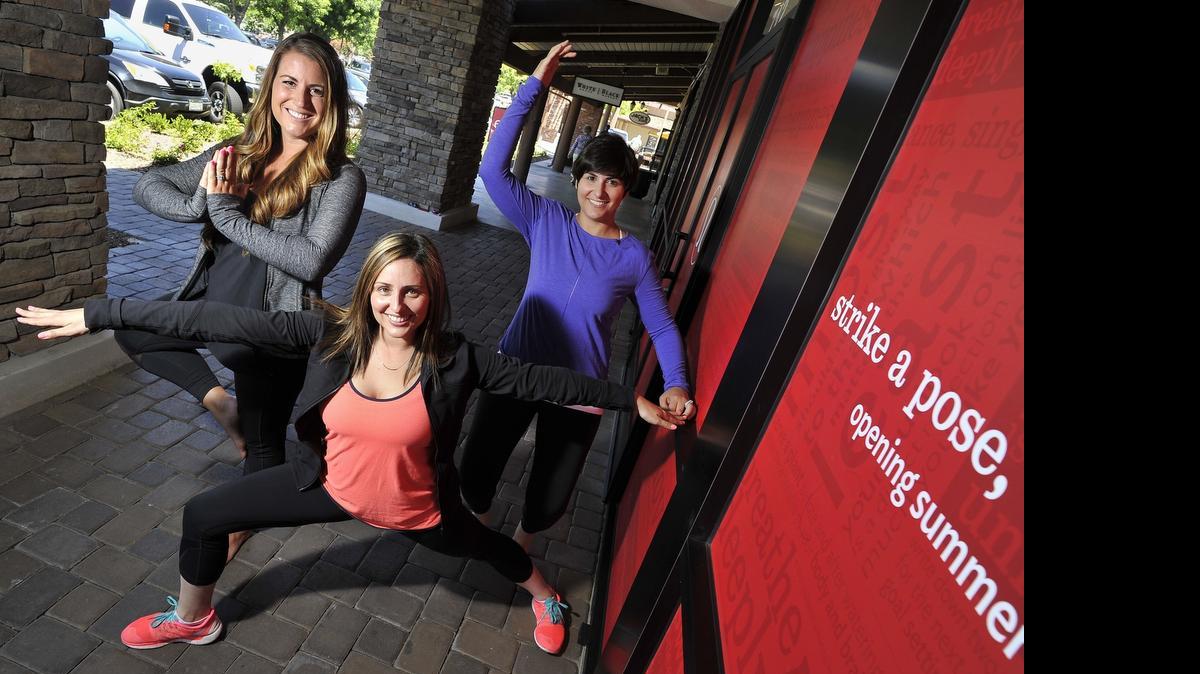 
Store manager Brittany Giersch, front, assistant managers Jordan Kaiser, left, and Sareen Bedoyan, right, strike poses in lululemon apparel, in front of the new lululemon store at Fig Garden Village.
